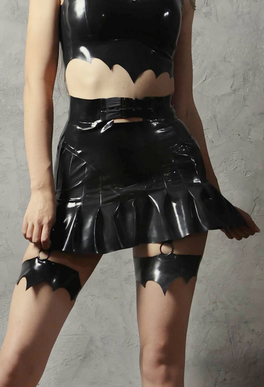 "Elvira" pleated mini skirt with bag strap buckles and bat leg garters